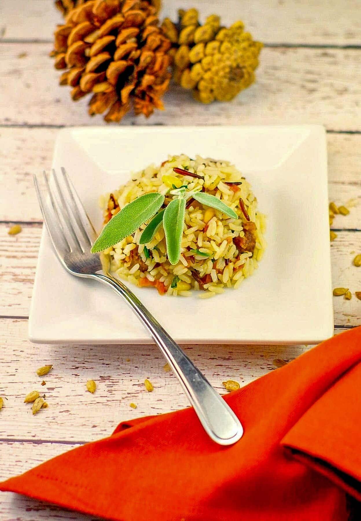 Apple rice shaped into a ball on a white plate with a fork
