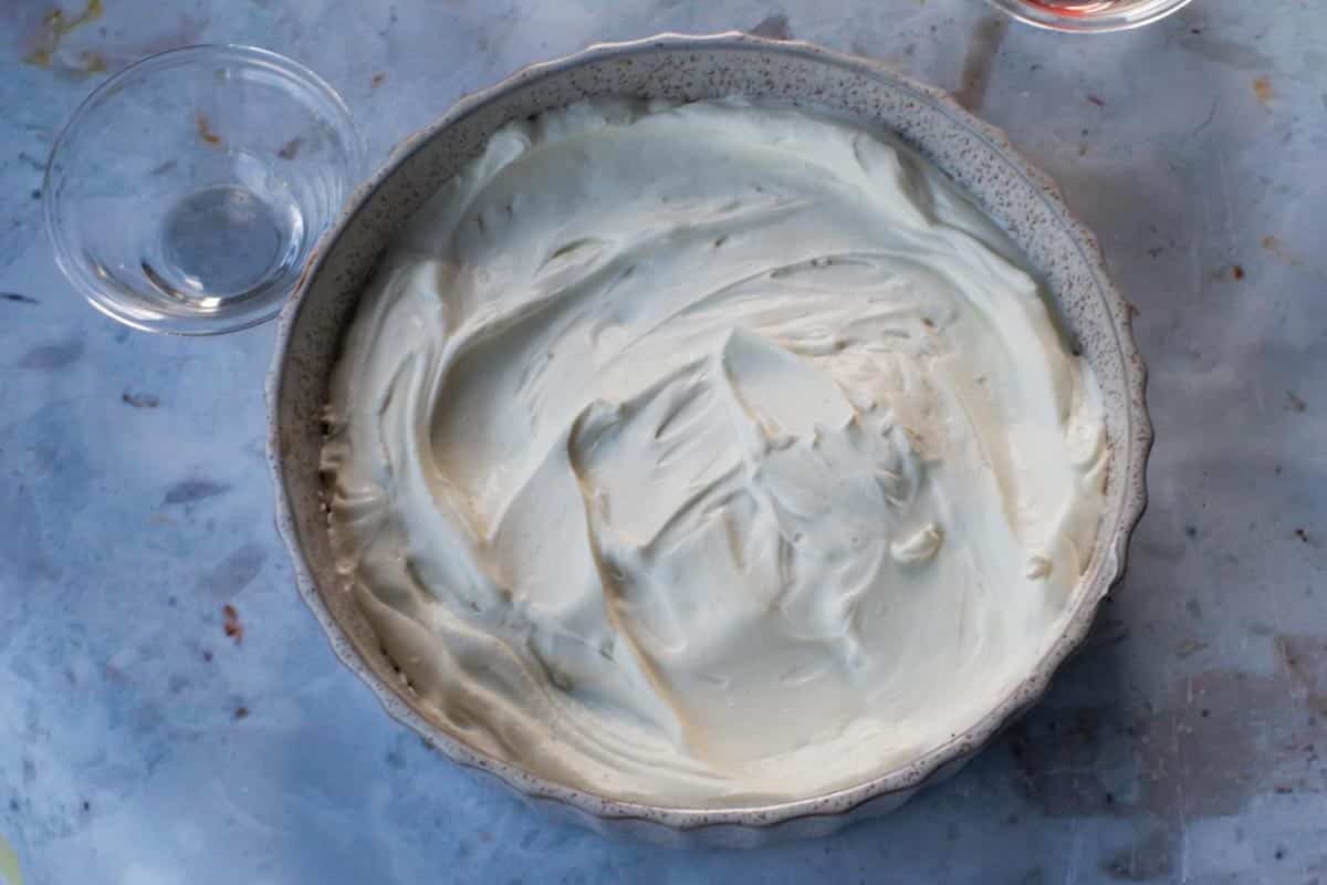 Whipped cream spread over chocolate base.