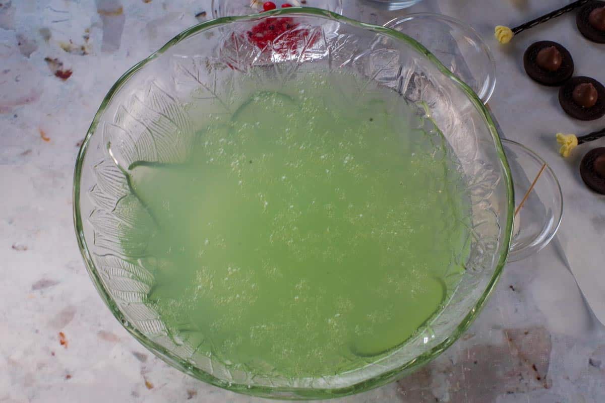 Liquids in punch mixed together in a punch bowl.