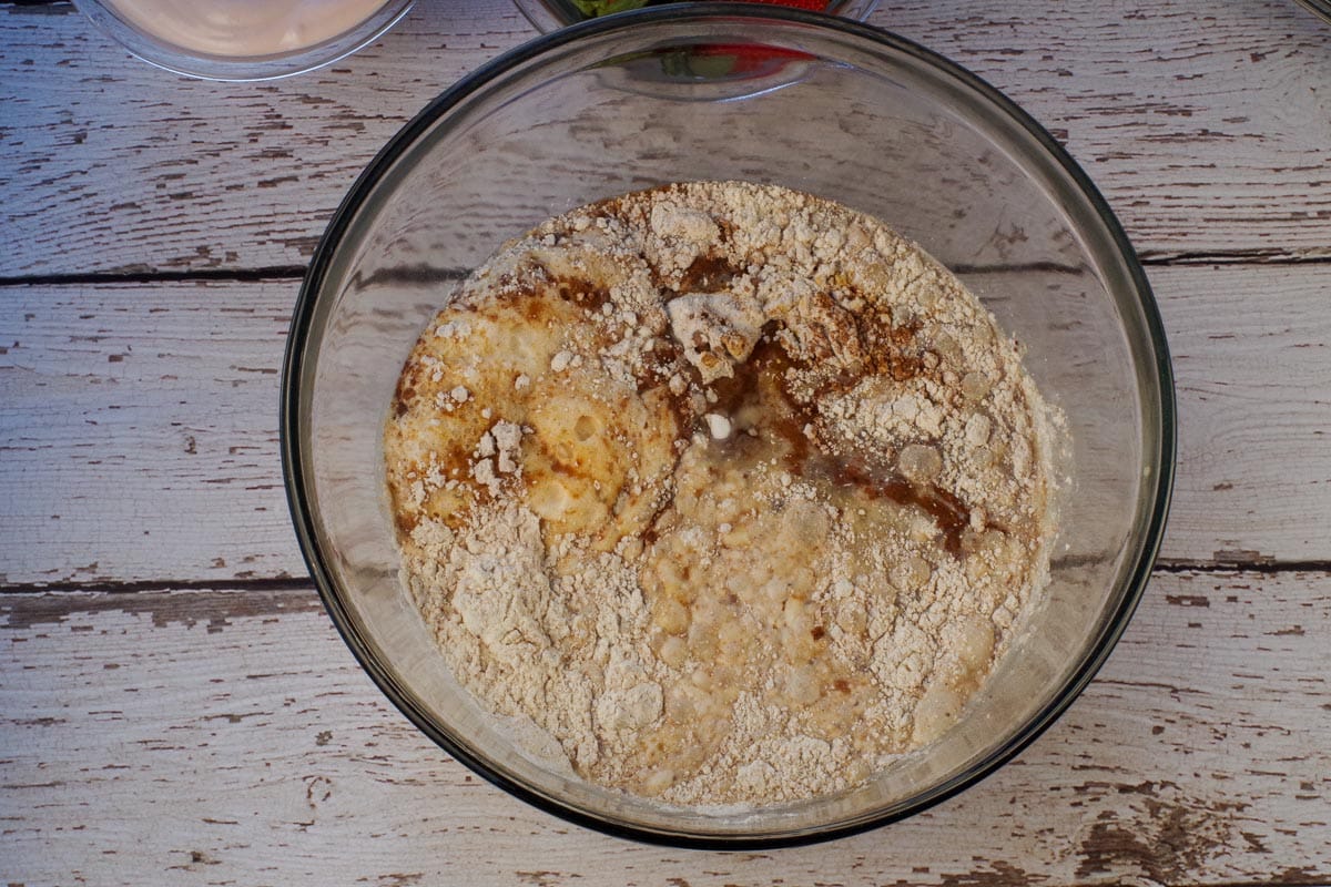 All ingredients (except yogurt and strawberries) in a glass bowl.