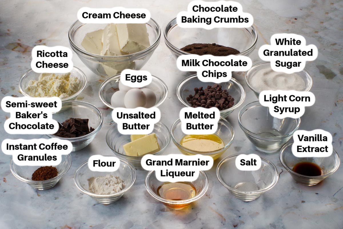 Grand Marnier Cheesecake ingredients in glass bowls, labelled.