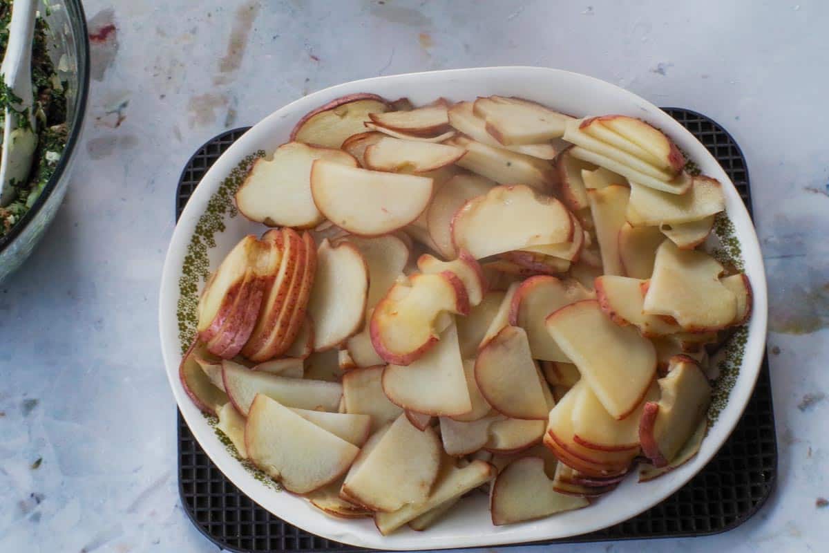 Cooked sliced potatoes on a platter.