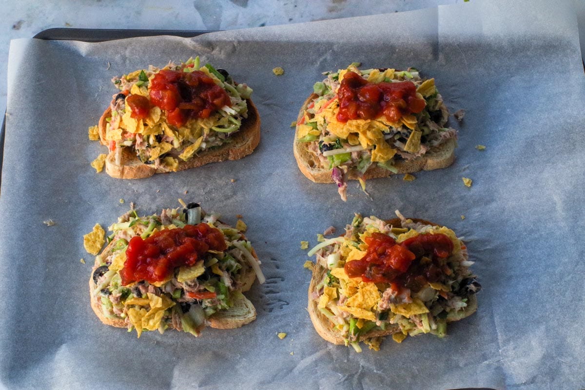 Crushed taco shells and salsa added on top of broccoli slaw.