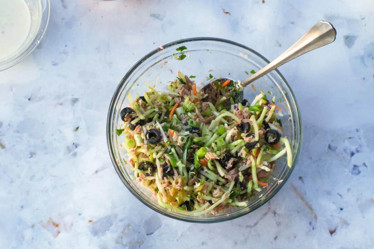 Broccoli slaw mixture in a glass bowl.
