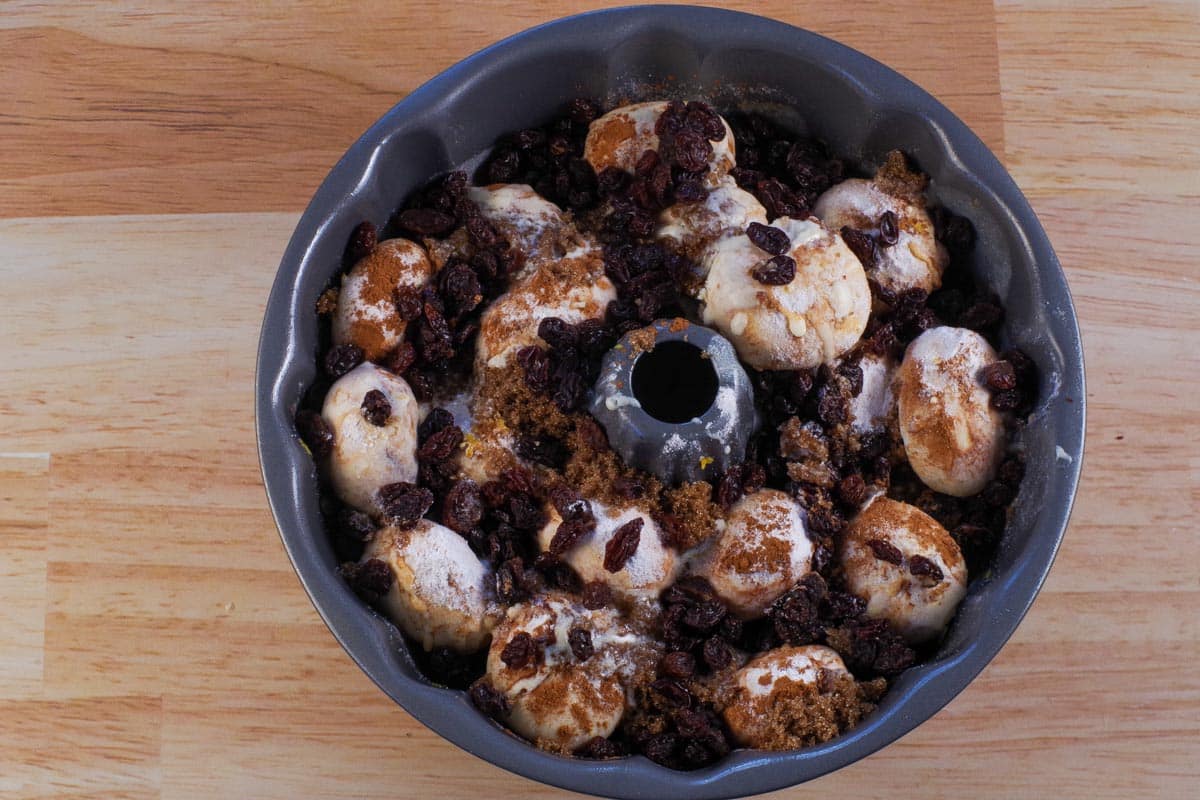 Buns covered with dry ingredients, nuts, raisins and butter mixture.