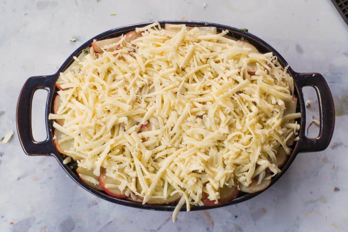 Cheese spread over final layer of potatoes in the casserole dish