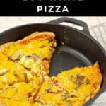 Healthy Breakfast pizza in a black cast iron pan with a piece missing (and turner beside the pan).