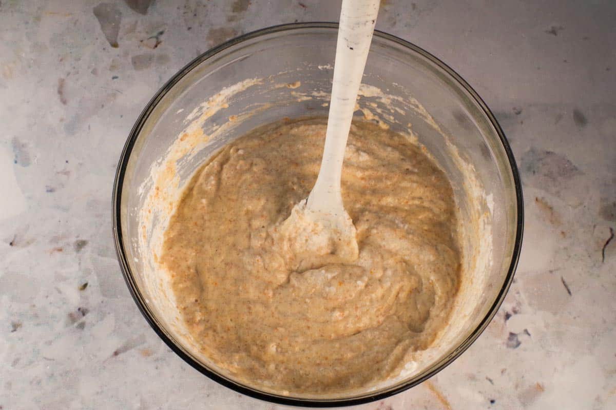 Egg whites folded into batter in large glass bowl.