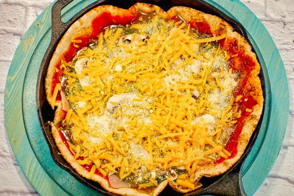 Ham, mushroom and cheeses added to healthy egg white breakfast pizza