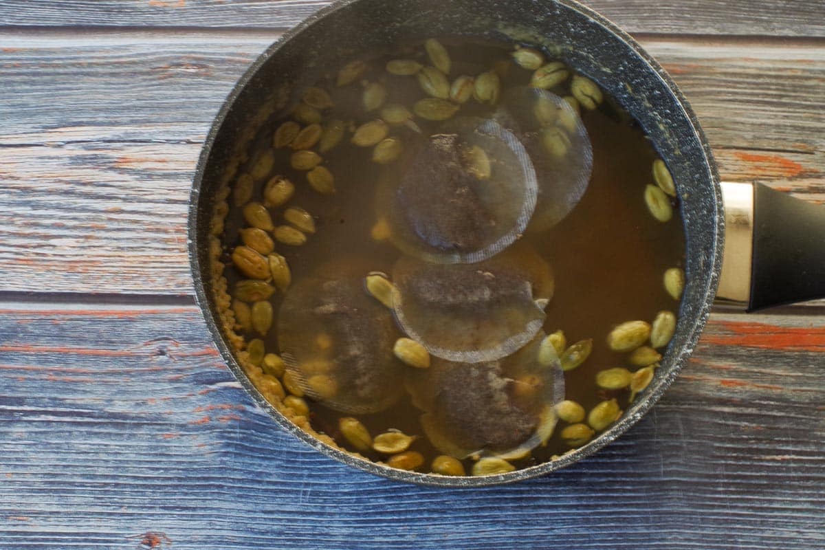 Tea bags added to spices and water.