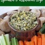 Weight Watchers Spinach and Artichoke Dip in a bowl on a platter surrounded by vegetables and mini pitas.