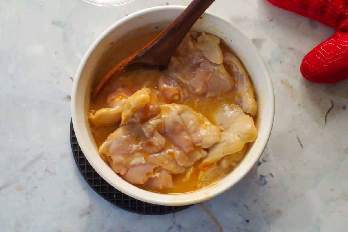 Chicken being stirred.