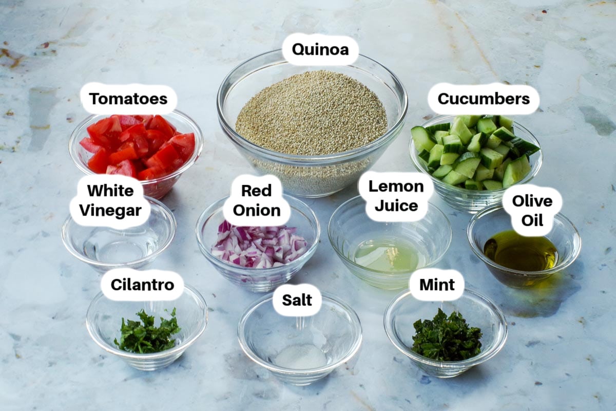Ingredients in Mediterranean Salad with Quinoa in glass bowls, labelled.