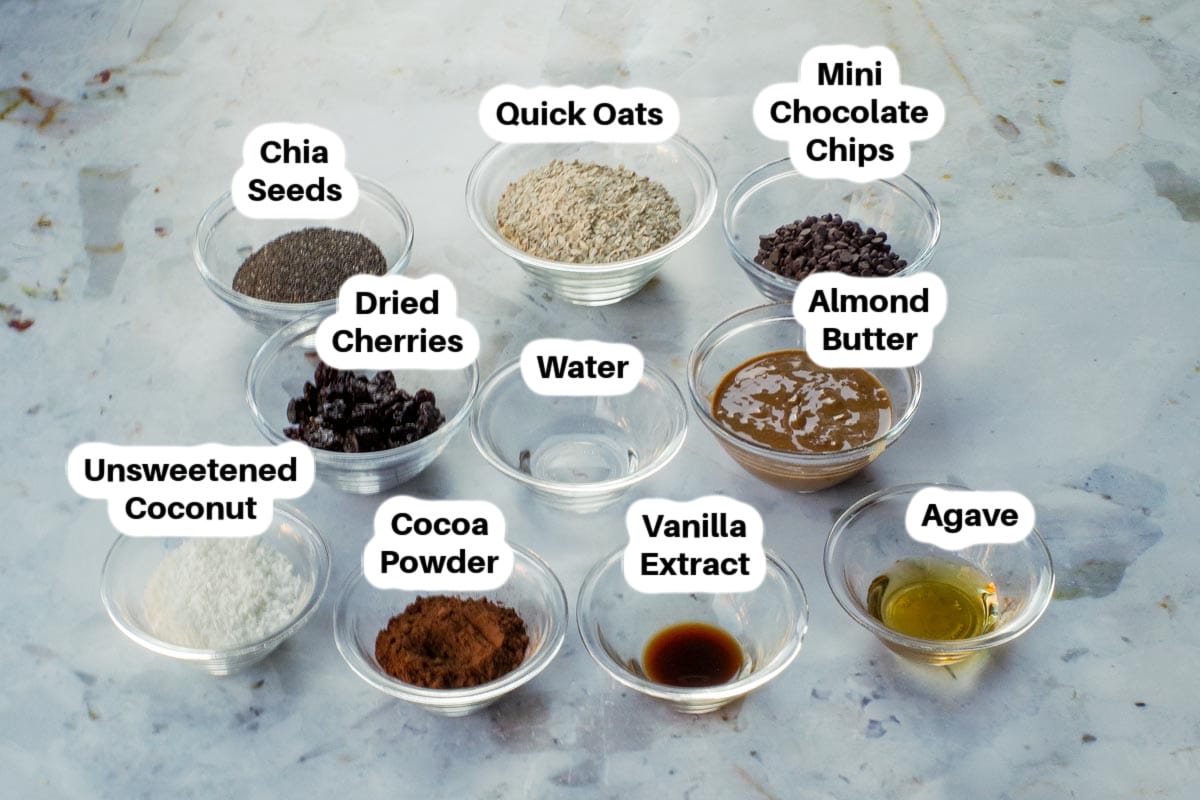 Ingredients in No Bake Black Forest Energy Bites in glass bowls, labelled.
