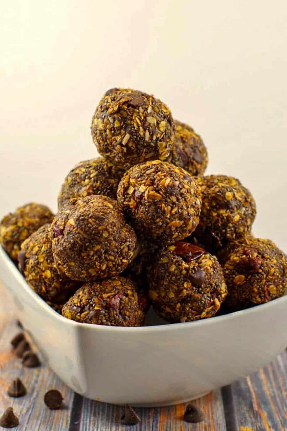 Chocolate Cherry Energy Bites piled on top of each other in a white dish.