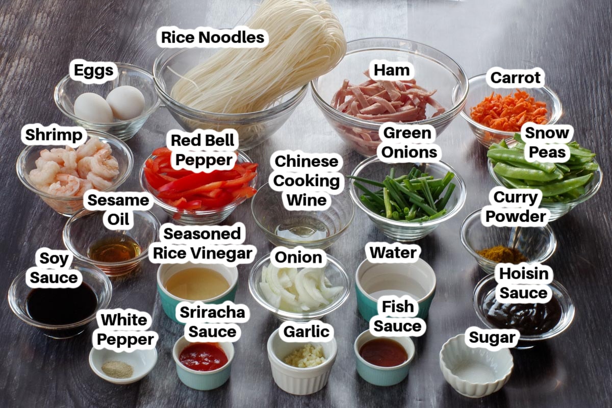 Ingredients in Singapore Fried Rice Noodles in glass bowls, labelled.