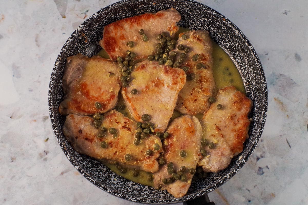 Mixture poured over pork in the frying pan.