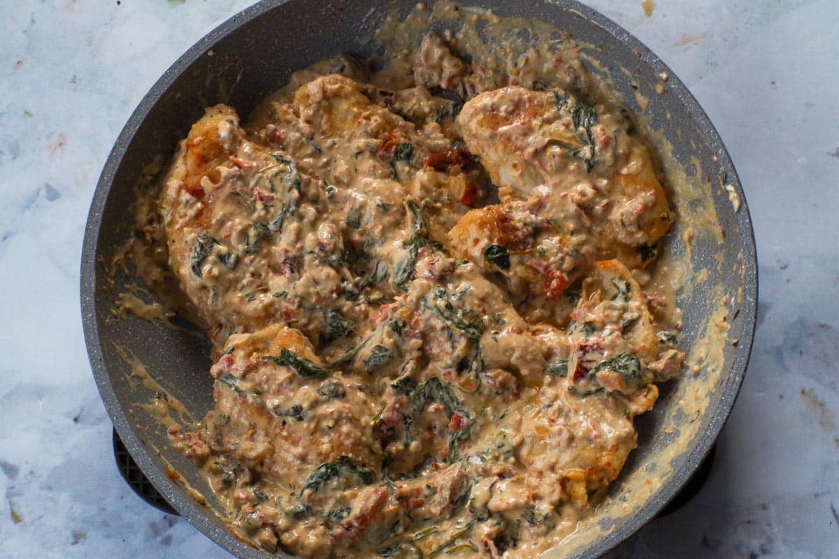 Chicken added back into the pan with sauce.