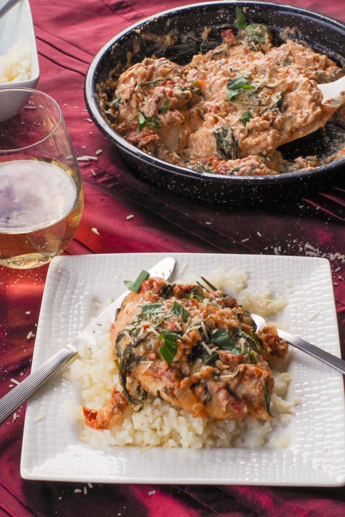 A piece of Healthy Marry Me Chicken on a bed of cauliflower rice.