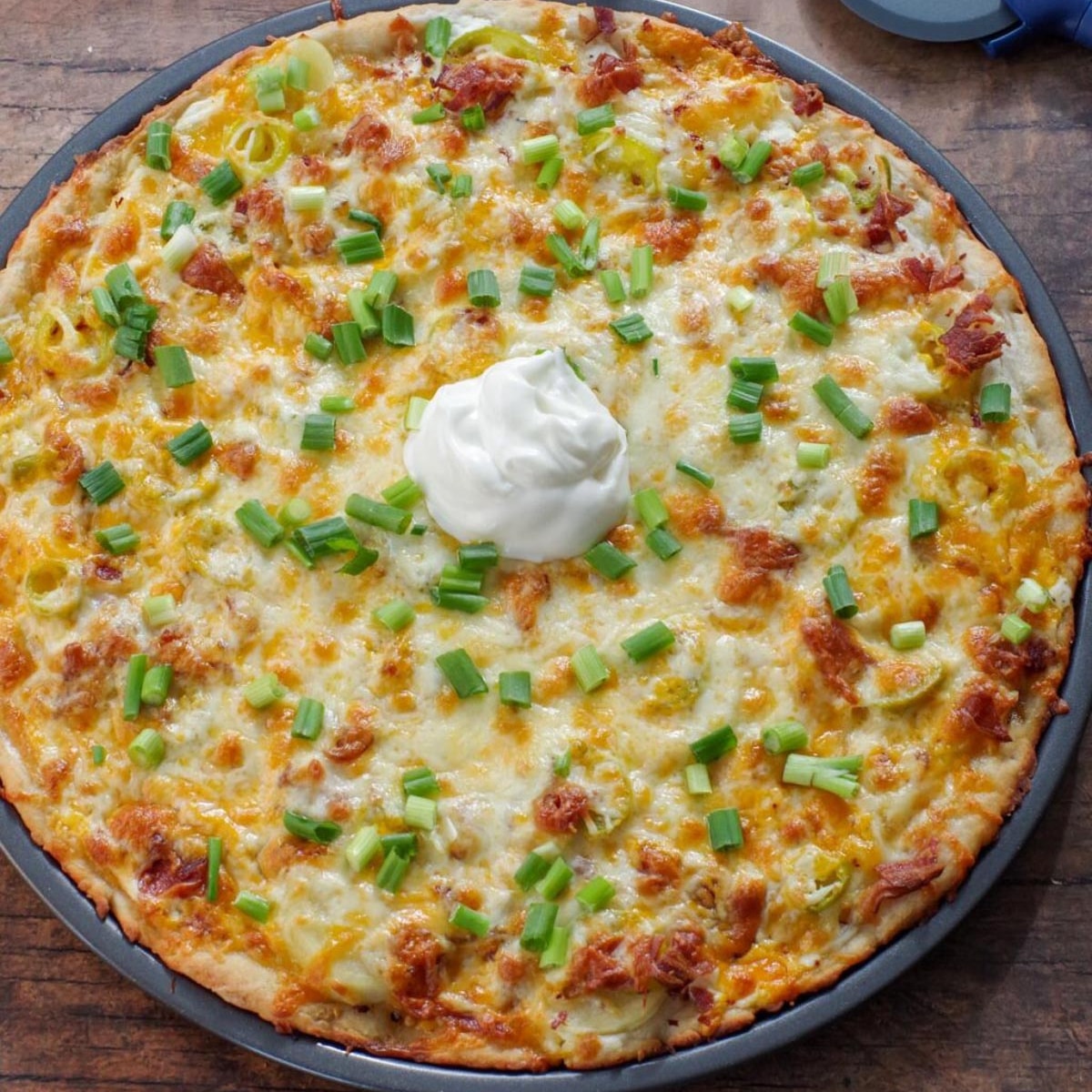 Baked Perogy Pizza with Sour cream in the middle