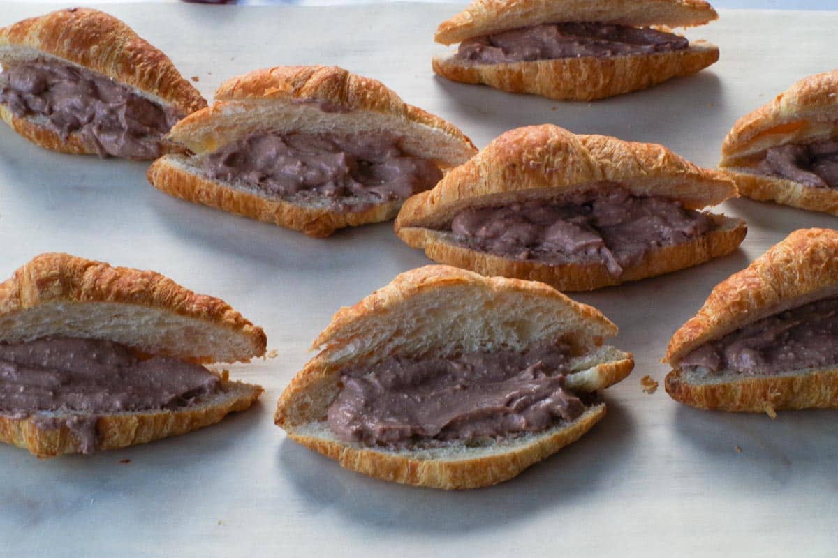 Pudding mixture added to croissants, divided by all of them.
