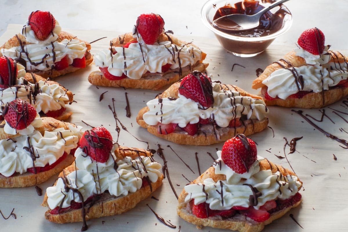 Chocolate drizzled over croissant eclairs.