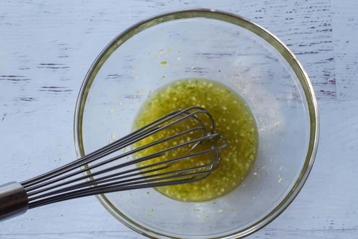 Marinade being whisked together in glass bowl.