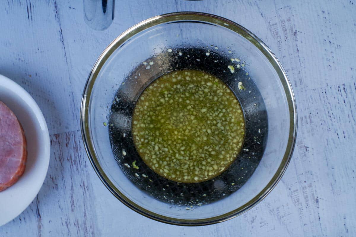 Marinade warmed up in glass bowl.