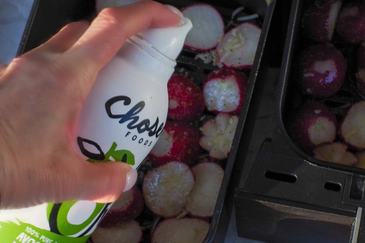 Radishes being sprayed with non- propellant avocado oil spray.