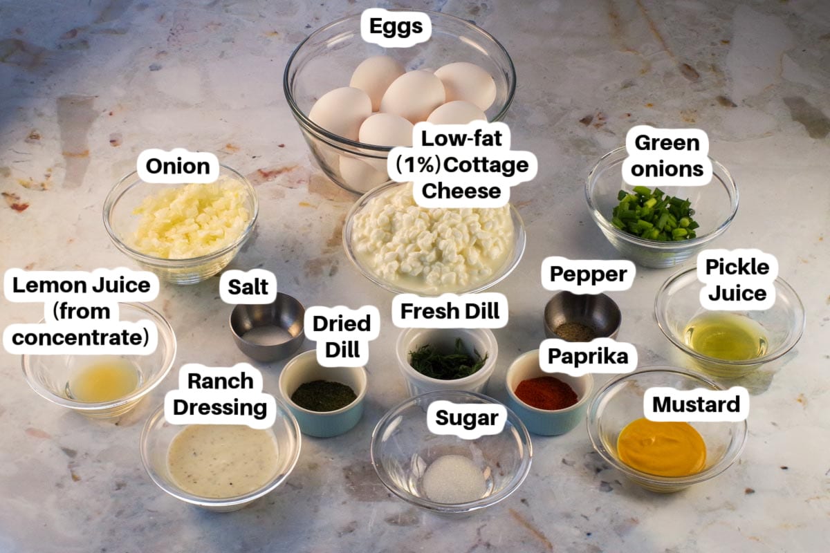 Ingredients in Dill Deviled Egg Dip in glass bowls, labelled.
