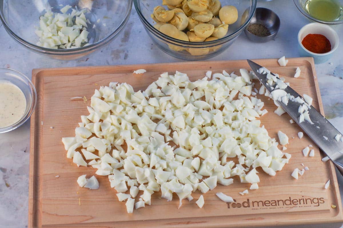 Chopped up egg whites on a cutting board.
