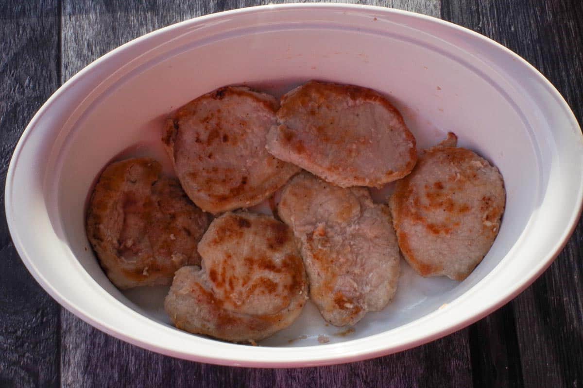Pork placed in prepared casserole dish.
