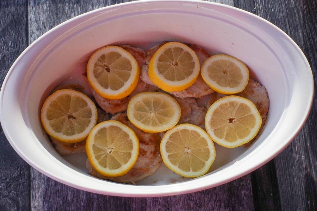 Lemon slices added to pork.