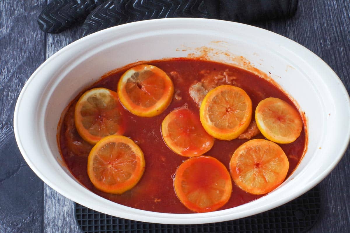 Baked pork chops in casserole dish.