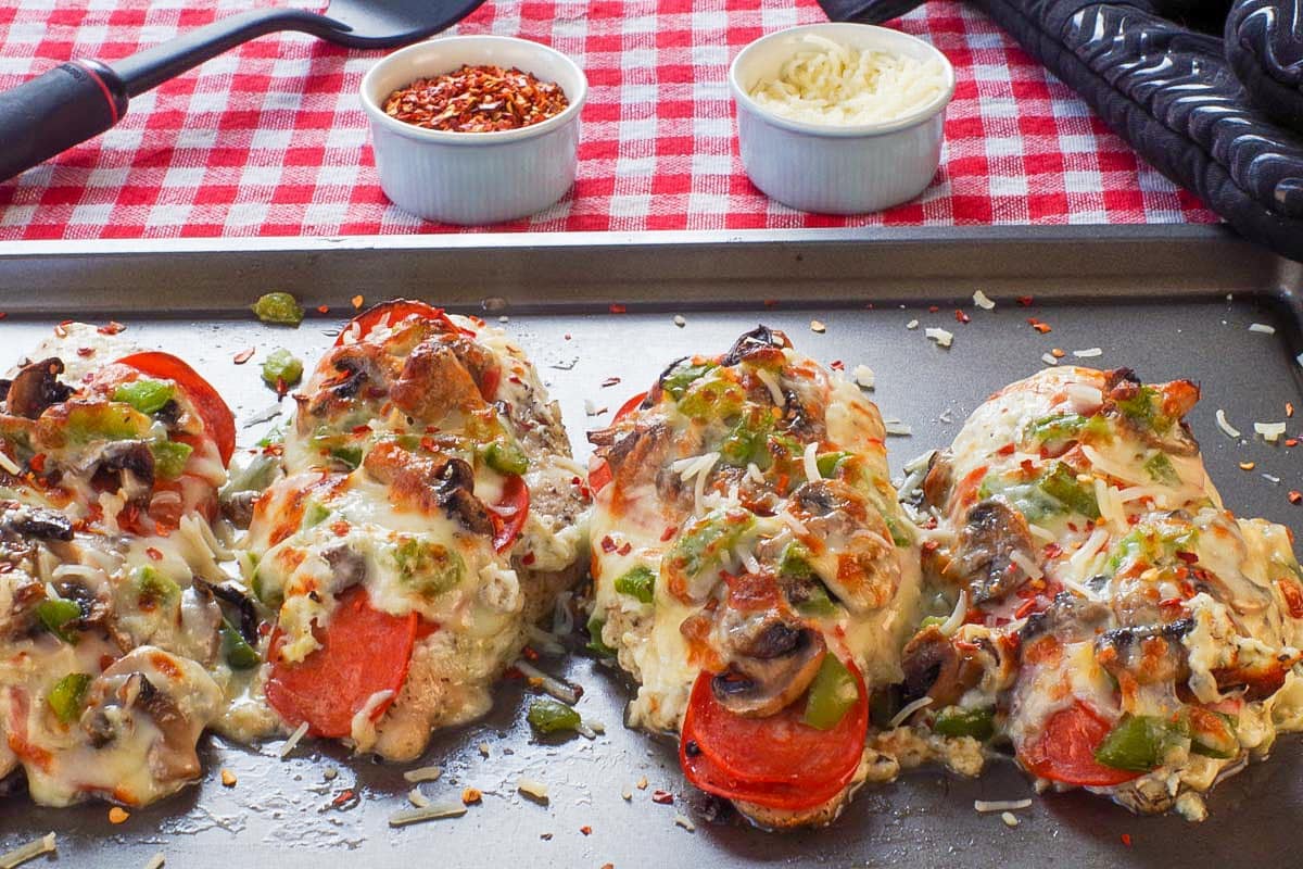 4 pieces of Healthy pizza chicken on a sheet pan.