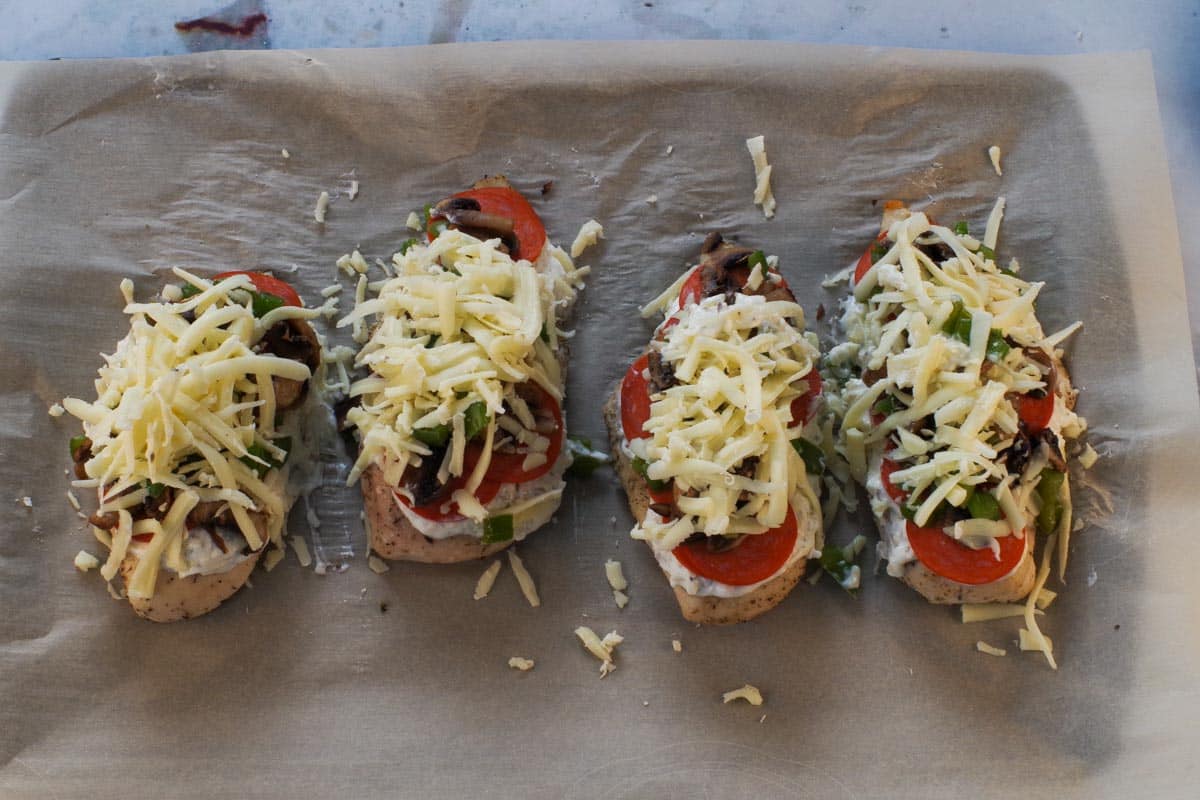 White Pizza Chicken breasts with mozzerella added on top of the sauce, pepperoni and veggies.