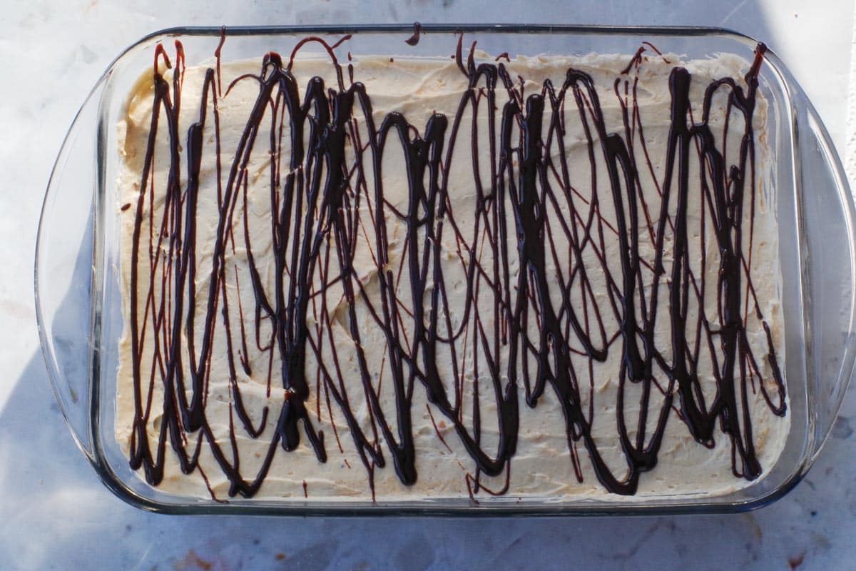 Chocolate drizzled over cream cheese/whipped cream base.