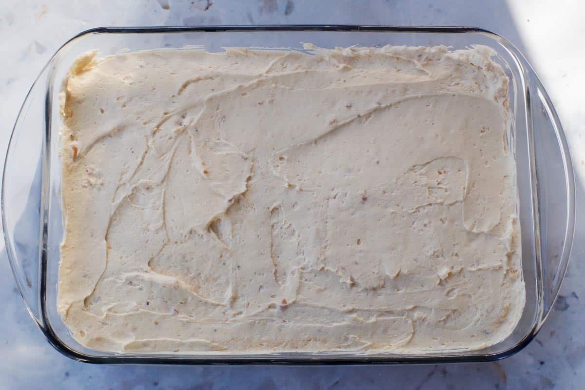 The cream cheese whipped cream mixture spread over the base in a 9x13 pan.