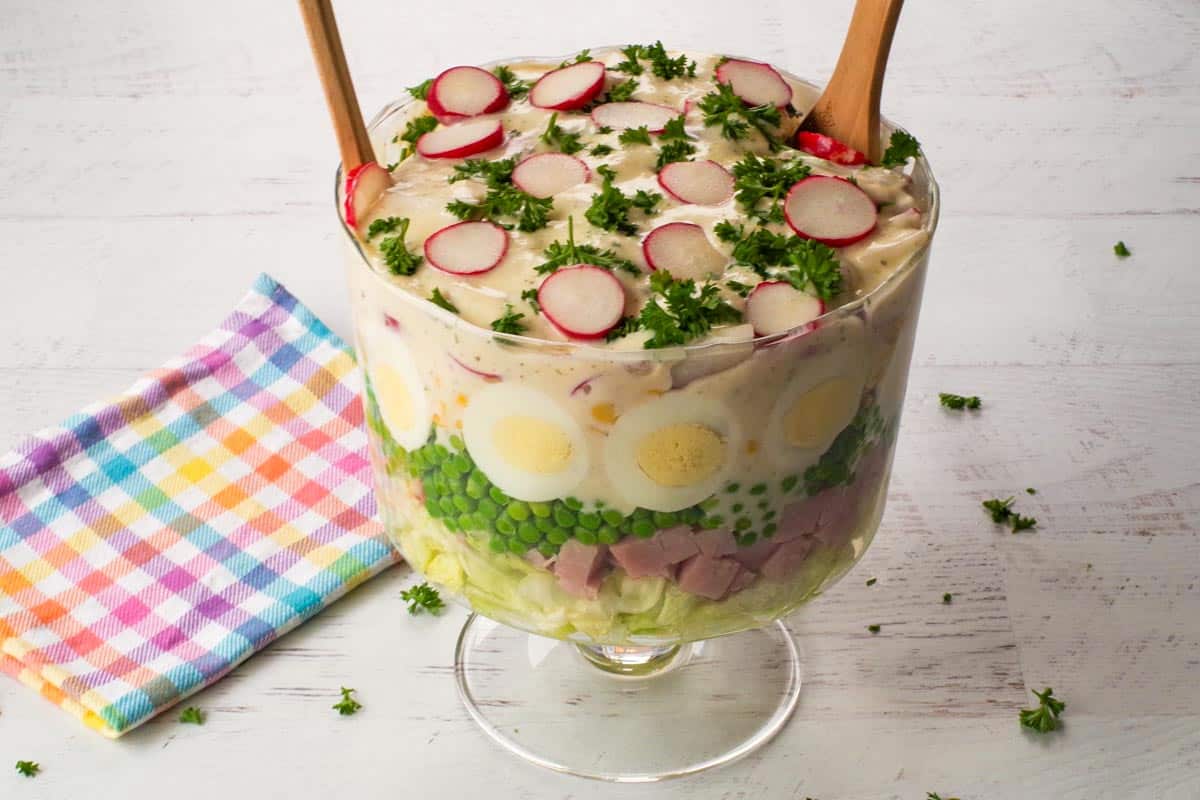 Layered Leftover Ham Salad in a trifle bowl.
