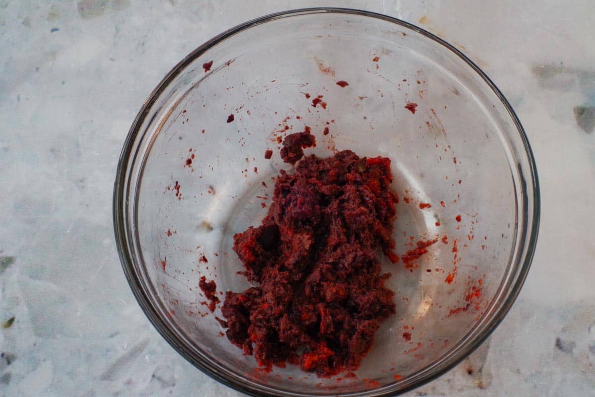 Black olives and red peppers blended together in a food processor.