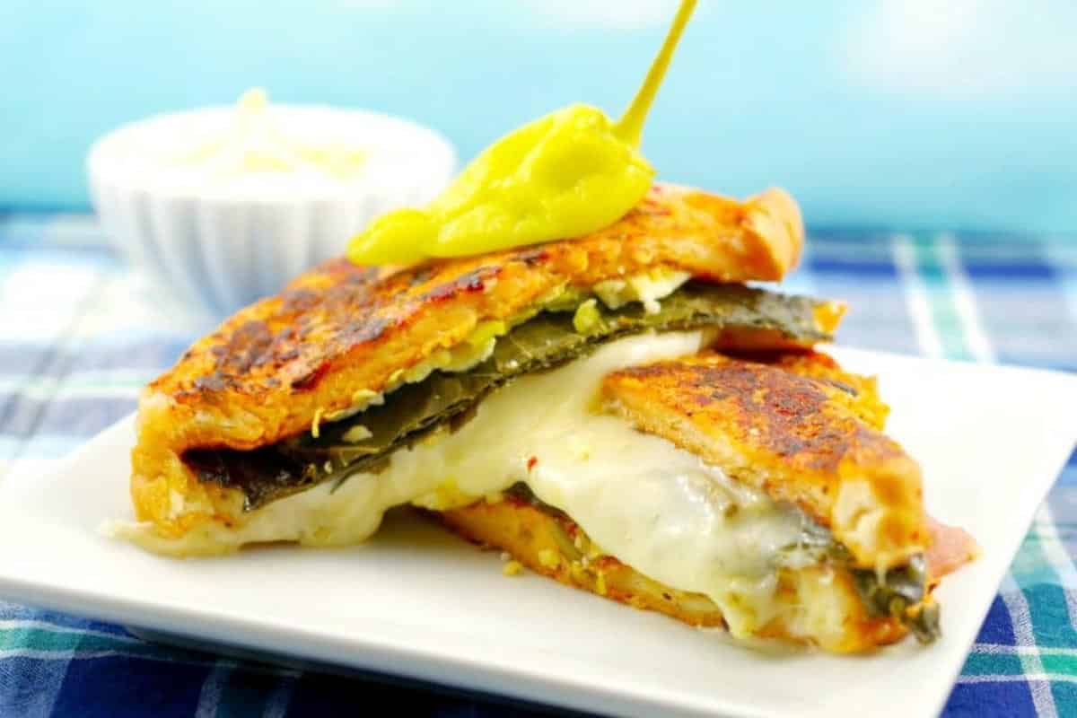 Mediterranean Sandwich is cut in 2 and stacked.