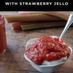 Rhubarb Sauce over yogurt in a white petal bowl, with fresh rhubarb in the background.