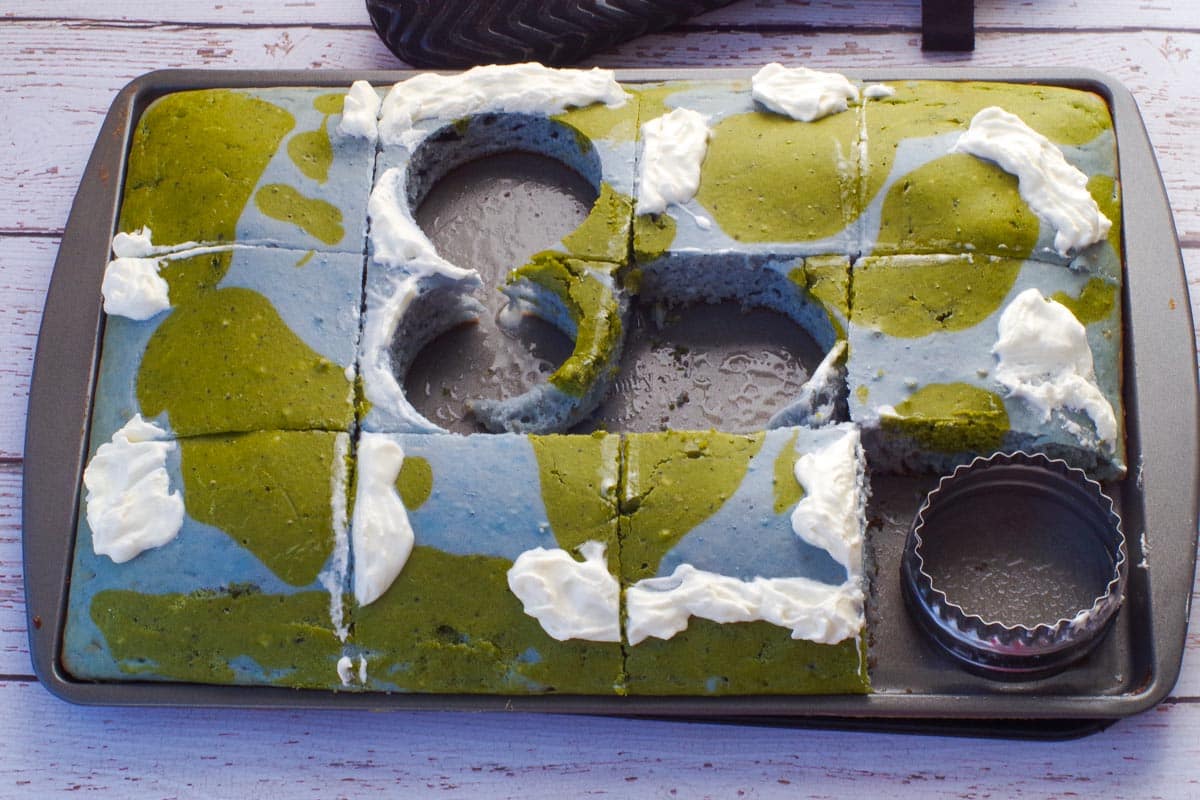 Earth Day Sheet Pan Pancakes being cut into "globes' with a round biscuit cutter.