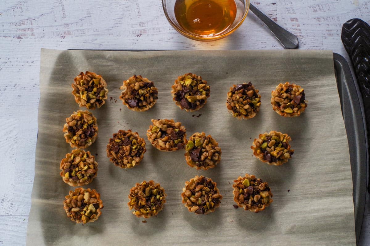 Baked Chocolate Baklava Bites on parchment lined baking sheet.