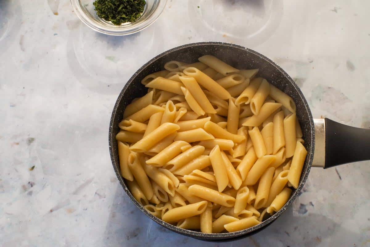 Cooked penne pasta in a medium pot.