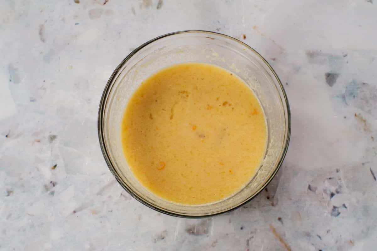 Wet ingredients mixed together in a medium glass bowl.