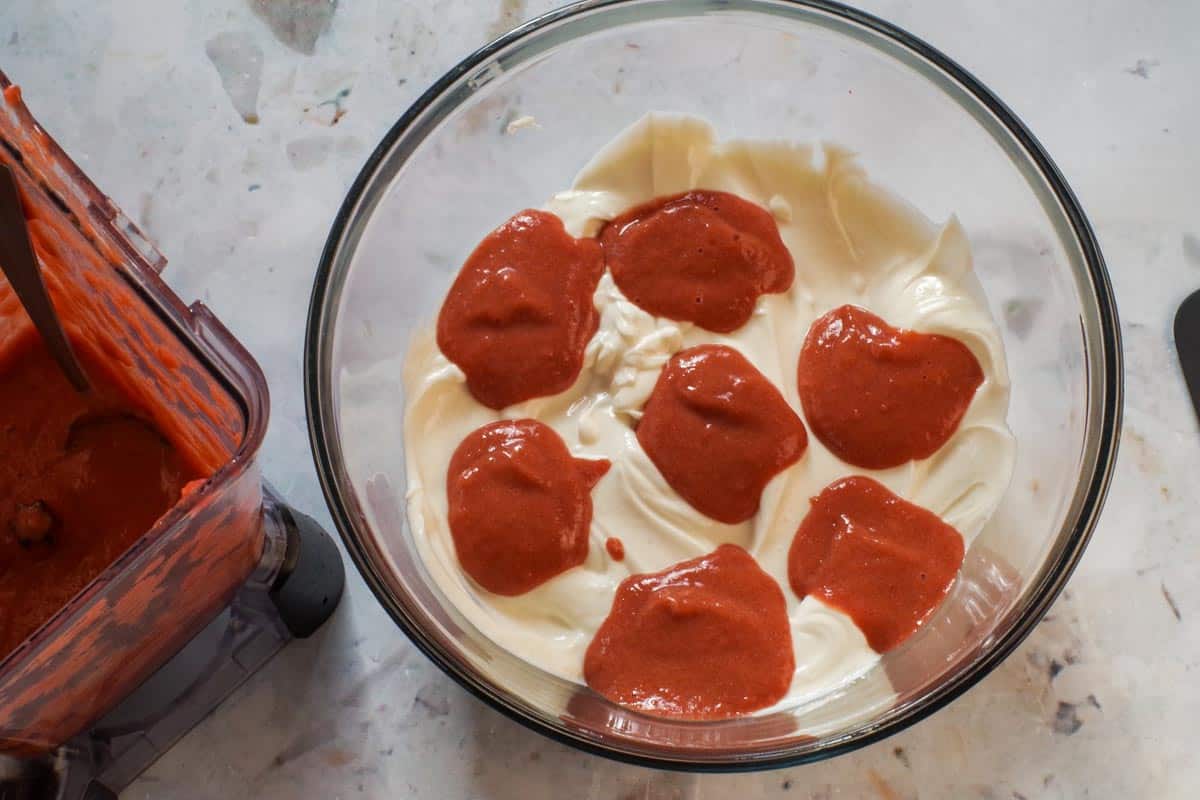 Dollops of rhubarb puree dropped on yogurt mixture.
