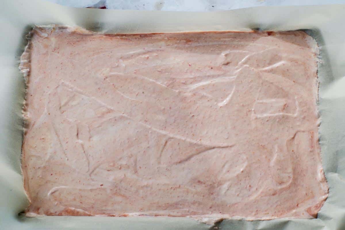 Rhubarb yogurt mixture spread onto parchment lined sheet pan.