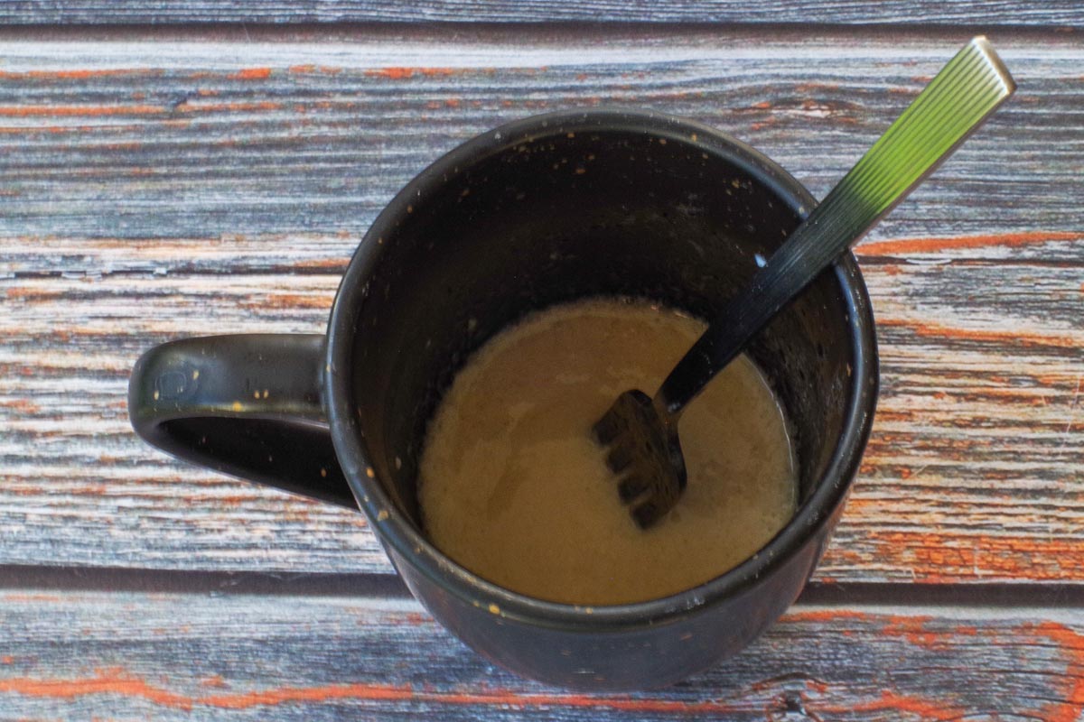 Wet ingredients being mixed together in rhubarb mug muffin.