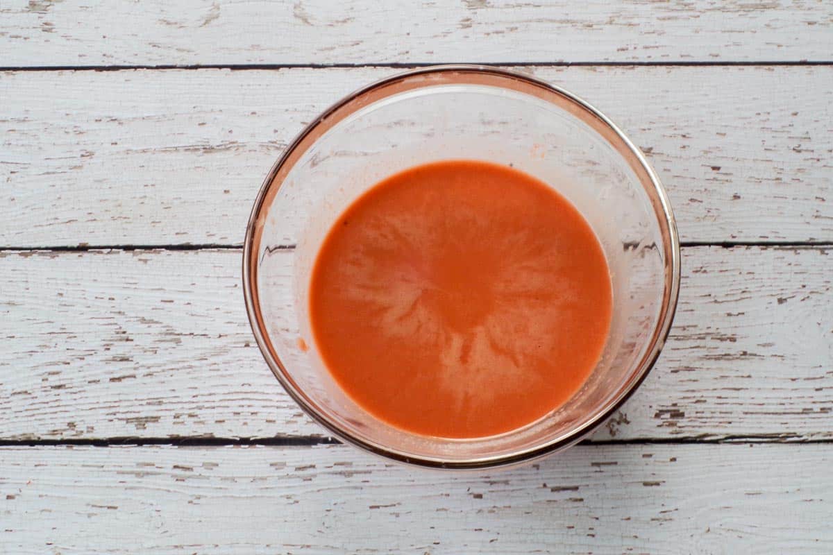 Remaining liquid (the rhubarb vinaigrette) in a medium glass bowl.
